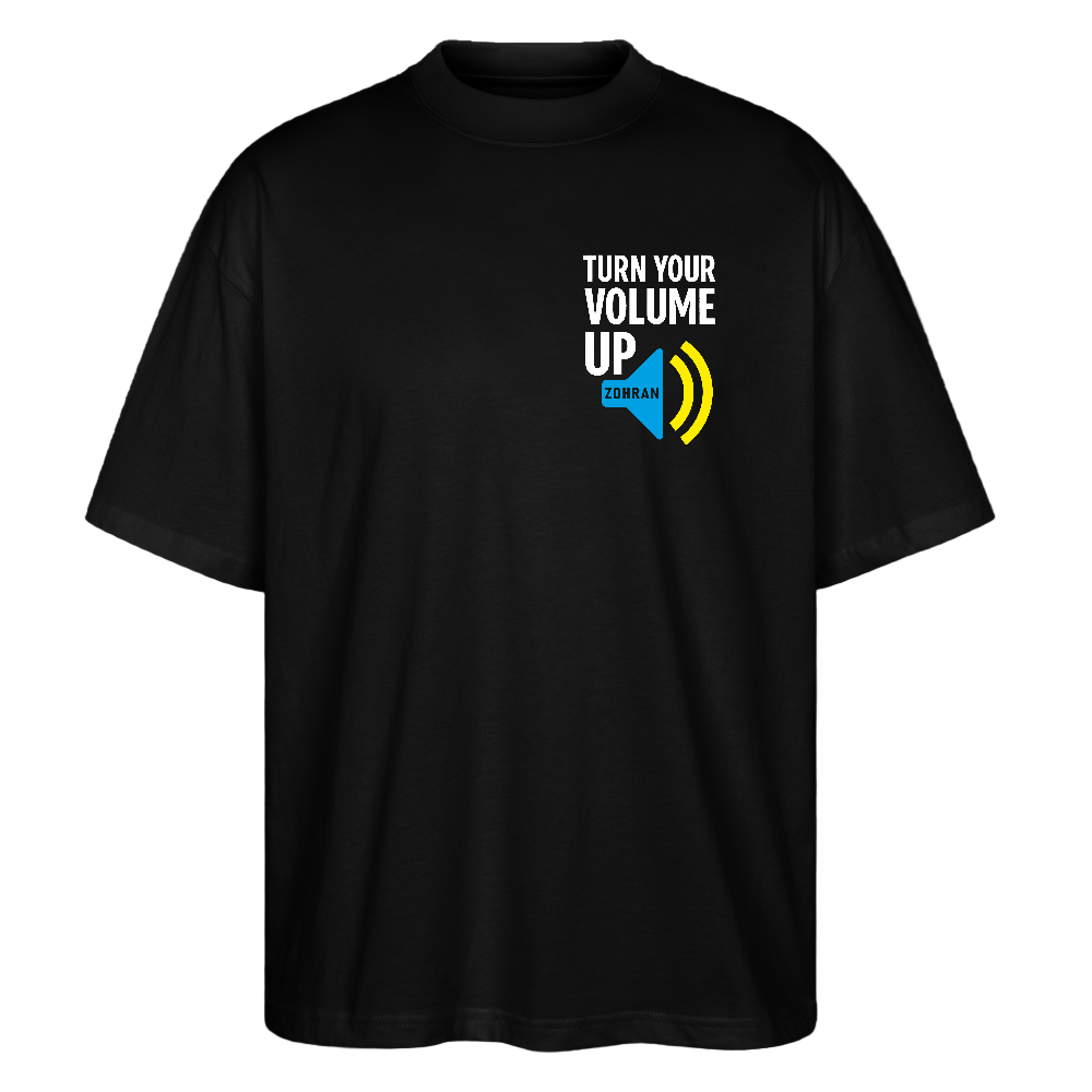 Front on black tee: "Black oversized unisex t-shirt with white TURN YOUR VOLUME UP chest print and blue ZDRAM speech bubble with yellow sound waves"